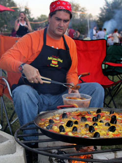 Chef Eric Paz cooking paella over an open fire